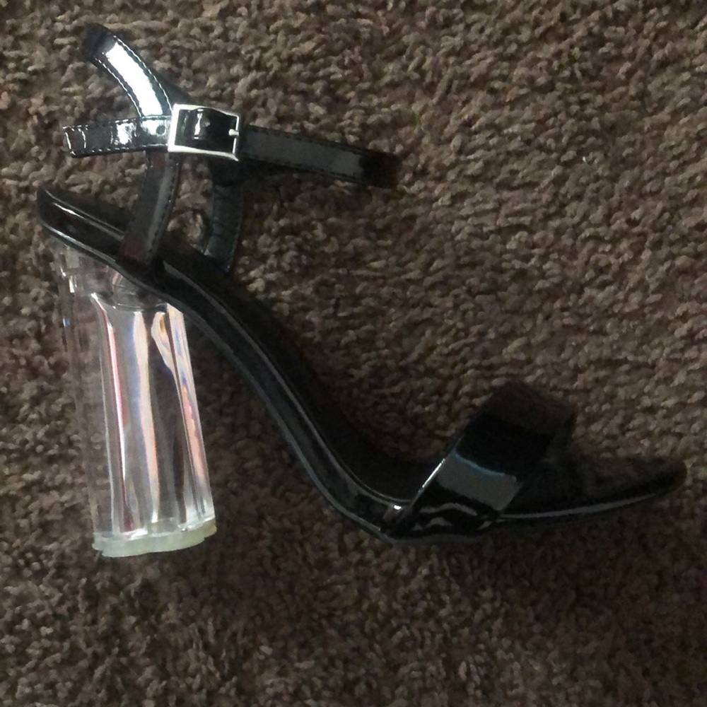 Black heels with a flower print bottom. 7 1/2